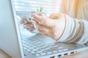 woman using laptop and smartphone, searching web, browsing information, Close up of business women working with typing on laptop empty at workplace.Selective focus photo