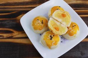 Chinese pastry puff, Beans cake with salted egg yolk lay on wood photo