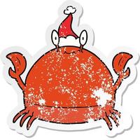 distressed sticker cartoon of a crab wearing santa hat vector