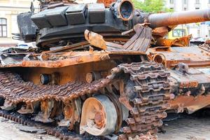 Destroyed rusty Russian tank on the city square. photo