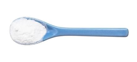 sodium bicarbonate in ceramic spoon isolated photo