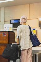 Woman passengers with luggage check in at the airport. photo