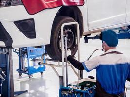 Auto mechanic working in car service centre photo