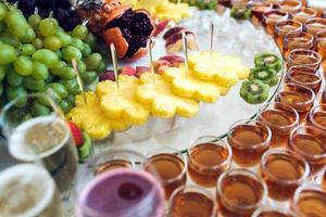 Rich buffet, whiskey, bourbon, champagne, wine and fruit. photo