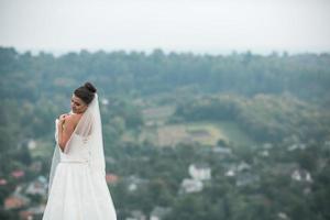 beautiful young bride poses for the camera photo