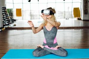 Woman in yoga class with VR headset photo