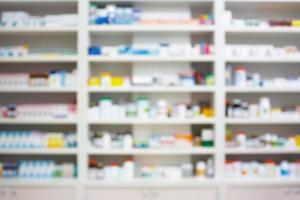 blur shelves of drugs in the pharmacy shop photo