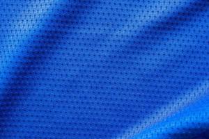 Blue color fabric sport clothing football jersey with air mesh texture background photo