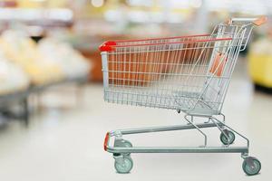 Supermarket grocery store with empty shopping cart photo