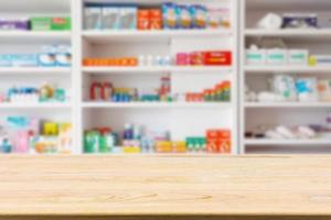 Pharmacy drugstore counter table with blur abstract backbround with medicine and healthcare product on shelves photo