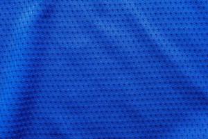 Blue color fabric sport clothing football jersey with air mesh texture background photo