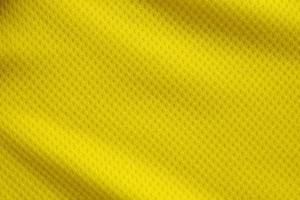 Yellow color football jersey clothing fabric texture sports wear background, close up photo