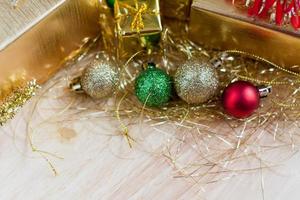 gift box with christmas ornaments on wood table photo