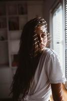 Young woman near the window in the morning photo