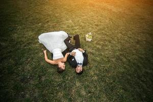 Wedding couple lying on the grass photo