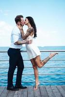 Guy and girl on the sea pier photo