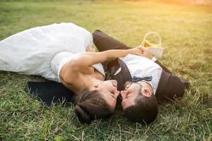 Wedding couple lying on the grass photo