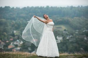 beautiful young bride poses for the camera photo