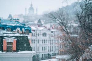 Copious snowfall over the city with the roofs photo