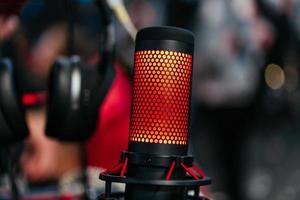 Professional studio condenser microphone attached to shock mount photo