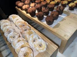 Lines of fresh delicious donuts on bakery shop, tasty multiple donuts, Selective focus donuts photo