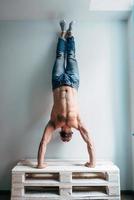 Man posing on camera, standing upside down photo