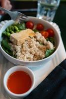 Healthy breakfast bowl with porridge and fresh vegetable salad photo