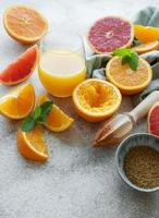 Glass of juice and citrus fruits photo