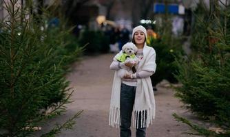 Beautiful young woman with a white dog photo