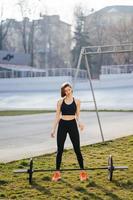 Strong woman exercising with barbell. Sports, fitness concept. photo