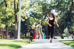 Mother and little son are walking in the park photo