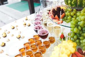 rich buffet, whiskey, bourbon, champagne, wine and fruit. photo
