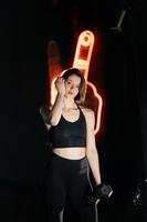 Beautiful young girl doing exercises in gym photo