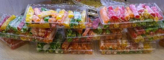 A variety of desserts, displayed in the window of the pastry shop, are on the shelf photo