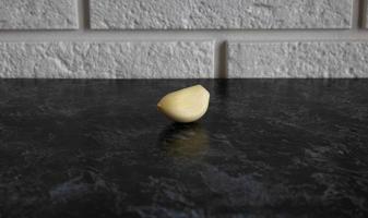 Garlic clove isolated on a black kitchen table background photo