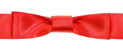 real red bow knot on wide satin tape isolated photo