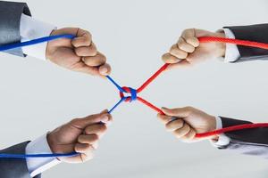 Hands of people pulling the rope, cooperation concept, Concept of business team using a rope as an element of the teamwork. photo