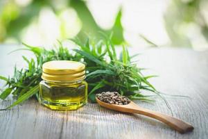 CBD oil hemp products, Medicinal cannabis with extract oil in a bottle on a wooden table. Medical cannabis concept photo