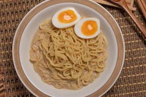 Udon and egg Japanese food with chopsticks and copy space photo