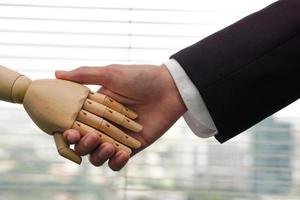 Robot Shaking hands with businessman. Artificial intelligence and technology future concept. photo
