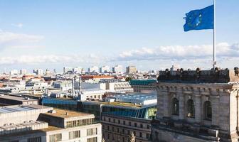 Berlin city and EU flag over Reichstag Palace photo