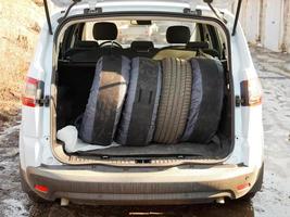 set of tires in trunk of car photo