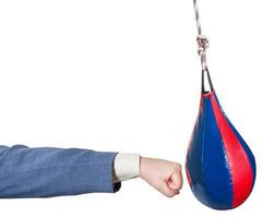 businessman punches punching bag isolated photo