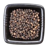 black pepper peppercorns in black bowl isolated photo