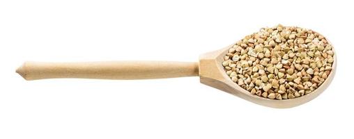 spoon with raw green buckwheat grains isolated photo