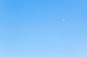 half of moon in clear blue sky photo