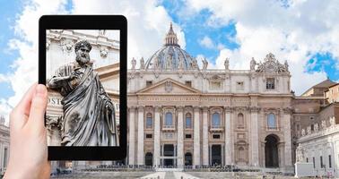 tourist photographs St Peter statue in Vatican photo