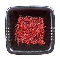 top view of crocus saffron threads in black bowl photo
