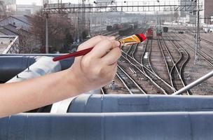 paintbrush paints red locomotive on railway photo