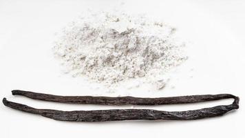 whole vanilla beans and pile of vanilla sugar photo